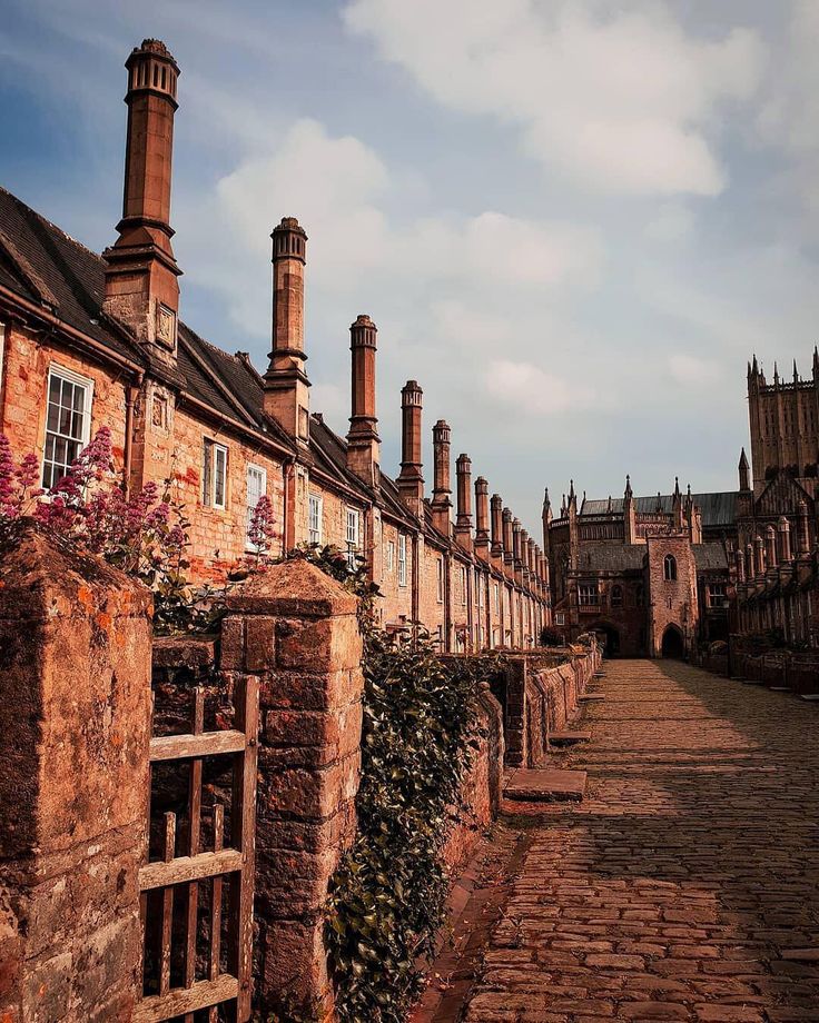 an old brick street lined with tall buildings