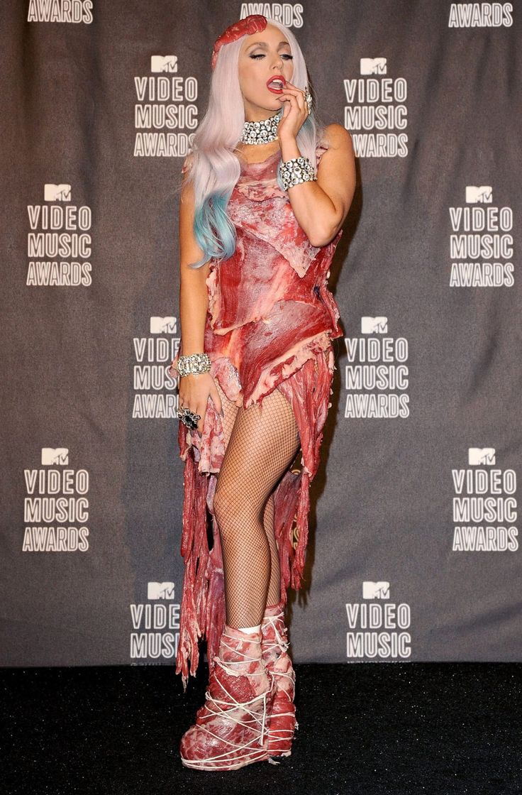 a woman dressed up as a zombie in front of a wall with the words video music awards written on it