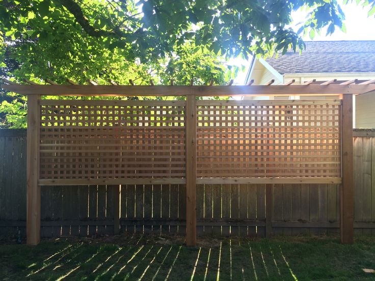 a wooden fence in front of a house