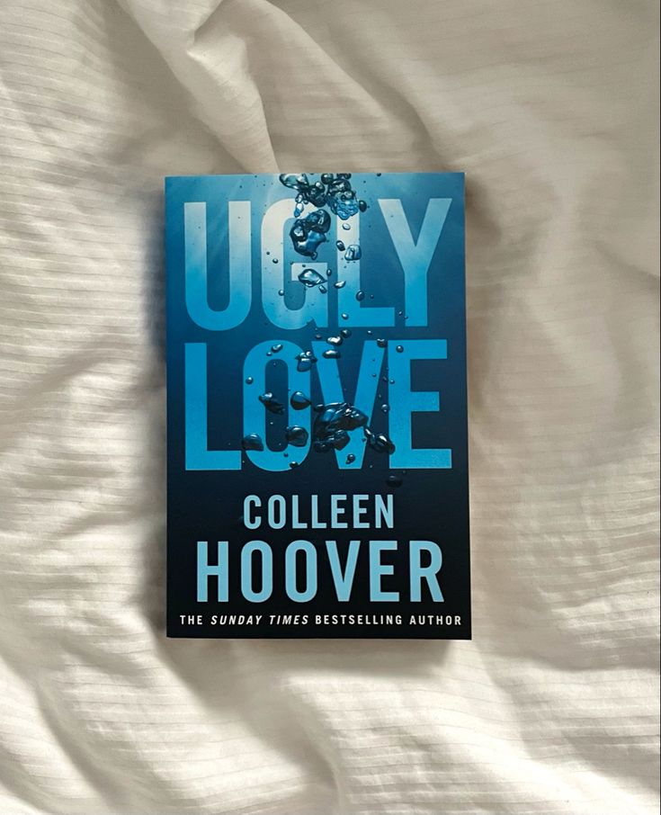 the book ugly love by colleen hoover is laying on top of a bed