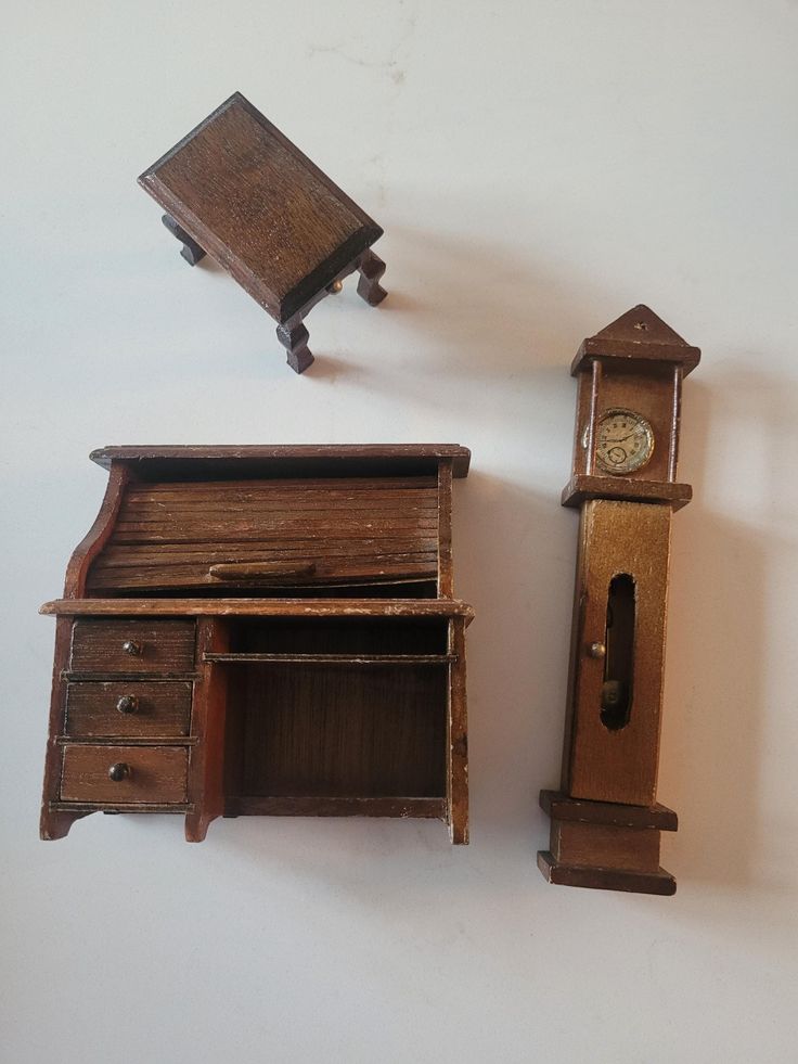 an old wooden desk with a clock on the top and another piece of furniture next to it