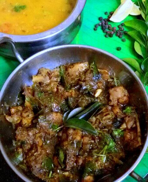 two pans filled with food sitting on top of a green tablecloth next to each other