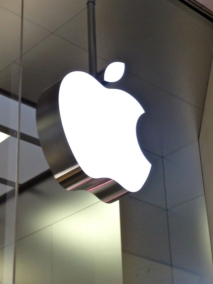 an apple logo hanging from the side of a building