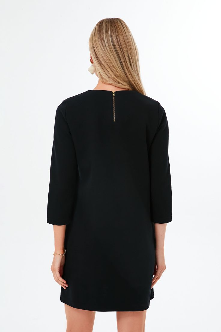 Inspired by the fine craftsmanship of a Parisian atelier, the Black Francoise Mod Mini Dress blends a 60s silhouette with minimalist details. Featuring a shift dress shape, long sleeves, and contrast pockets with buttons, this style is ultra-chic. Pair with gold jewelry for work and heels for date night! Crewneck Three-quarter length sleeves Contrast piping on pockets Gold button details on pockets Shift silhouette Mini length Material: 45% Cotton, 55% Polyester Care: Machine wash cold, tumble d 60s Silhouette, Minimalist Details, Mod Mini Dress, Contrast Piping, Dress Shapes, Dress Mini, Gold Buttons, Mini Black Dress, Three Quarter