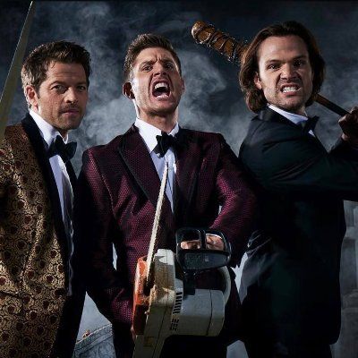 three men in tuxedos are holding guitars and looking at the camera with an angry look on their face