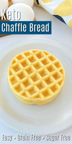 a white plate topped with waffles next to eggs