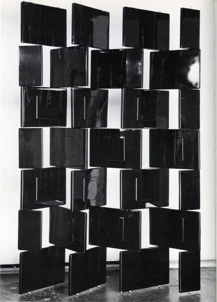 a black and white photo of an abstract sculpture made out of square blocks on the floor