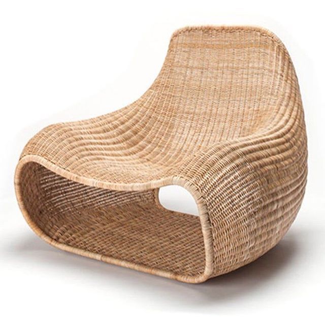 a chair made out of wicker sitting on top of a white floor