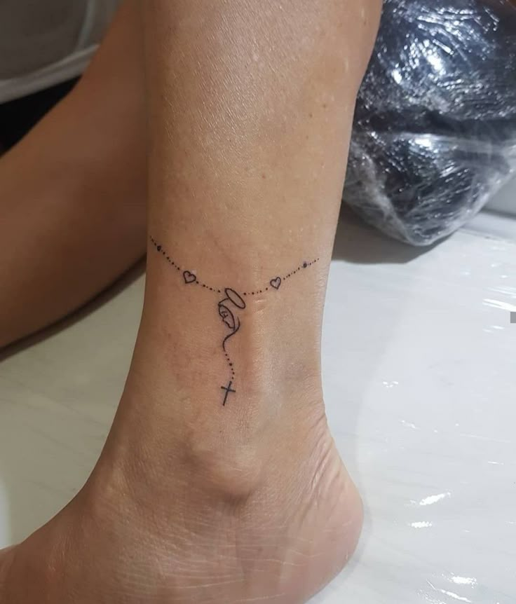 a woman's foot with a small tattoo on the ankle that reads, love