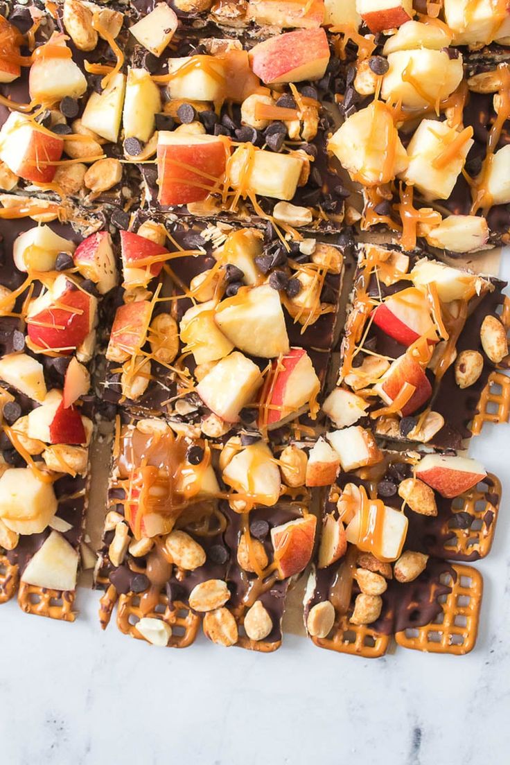 chocolate caramel apple waffles on a white marble counter top with chopped apples