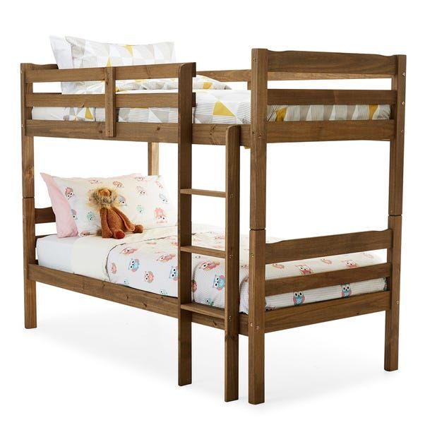 a wooden bunk bed with two sets of mattresses and pillows on top of it