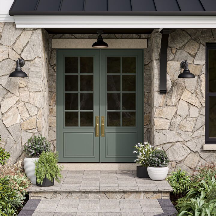 the front door to a house with two potted plants on either side of it