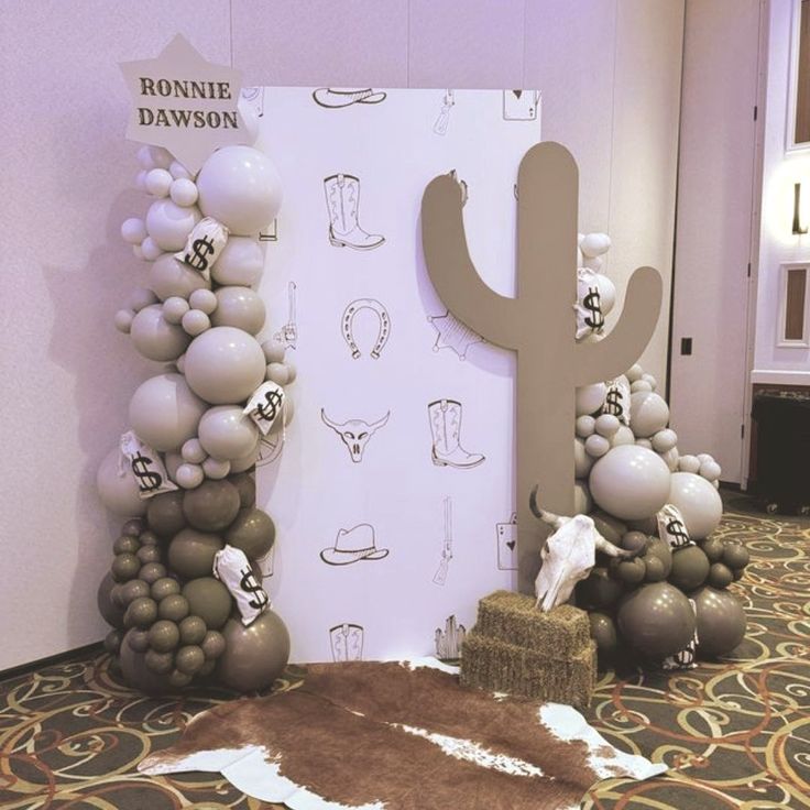 balloons are arranged in the shape of a cactus and boots on display at an event