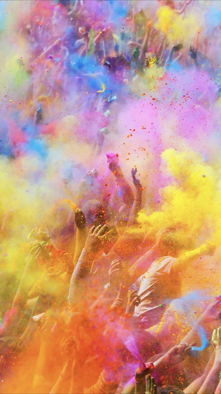 many people are throwing colored powder on each other