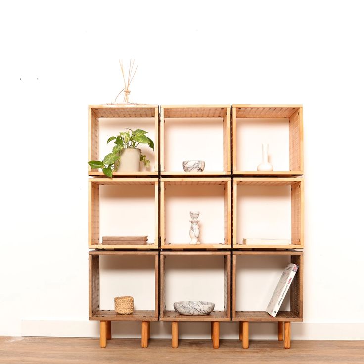 a wooden shelf filled with books and plants