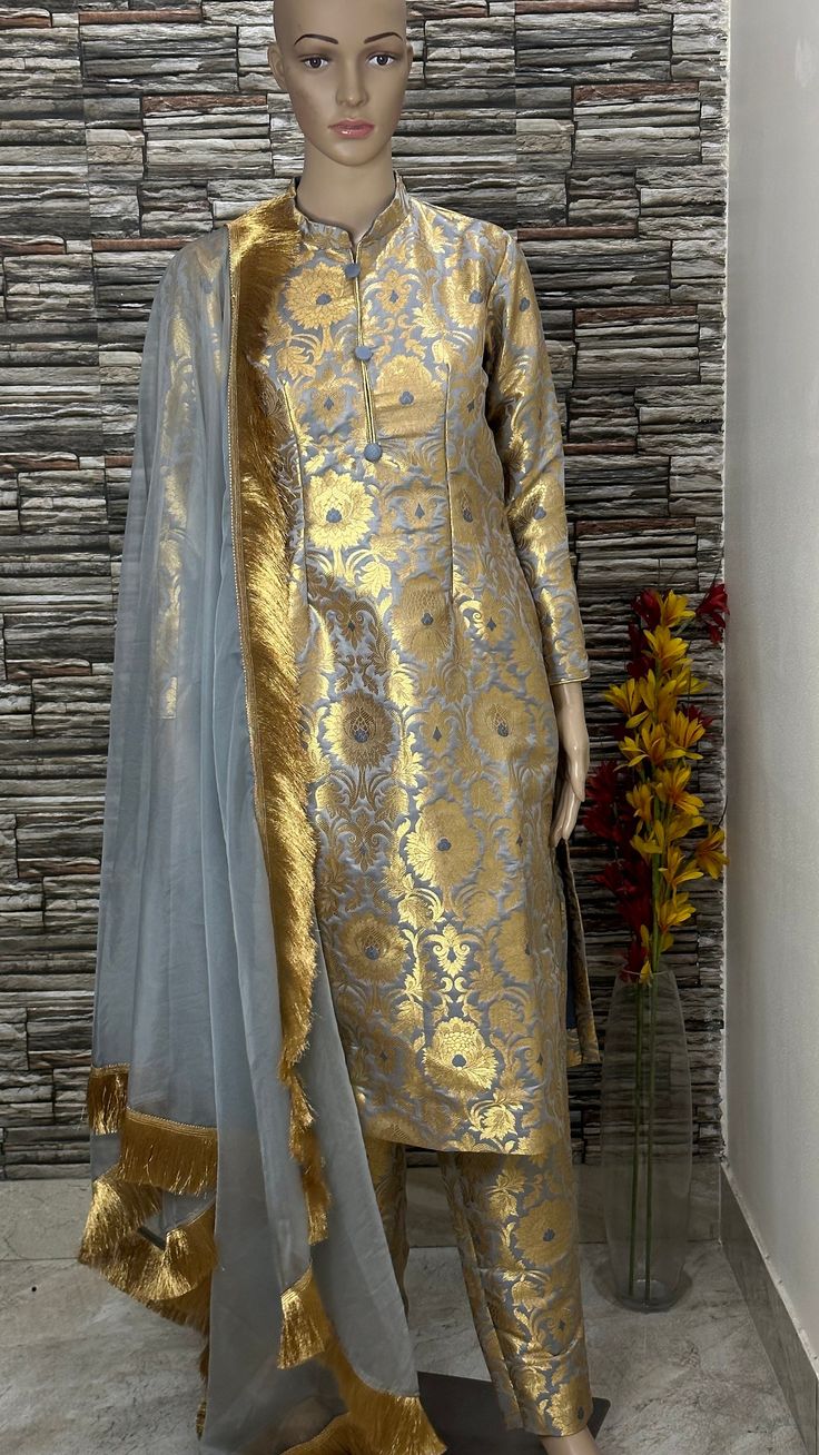 Custom made 3 piece brocade salwar suit. Stitching  For stitched dresses you can chose from size chart or can message us for customization.our team will send you size chart for customization. Feel free to convo for any details to help you in your selection because customize dresses cannot be return or exchange. Note: color may slightly vary because of different screen resolutions. We have an expert customization team .if you have any problem regarding taking measurements please convo for our help. All the measurements are rechecked before dispatch. Semi-stitched Gold Chanderi Lawn Suit, Elegant Banarasi Silk Kurta With Sheer Dupatta, Designer Gold Anarkali Set In Katan Silk, Elegant Designer Churidar With Zari Weaving, Elegant Jamawar Churidar With Sheer Dupatta, Elegant Anarkali Set With Zari Weaving, Designer Banarasi Silk Gold Anarkali Set, Designer Gold Tissue Silk Unstitched Suit, Designer Gold Banarasi Silk Anarkali Set