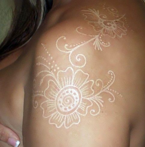 a woman with white tattoos on her back