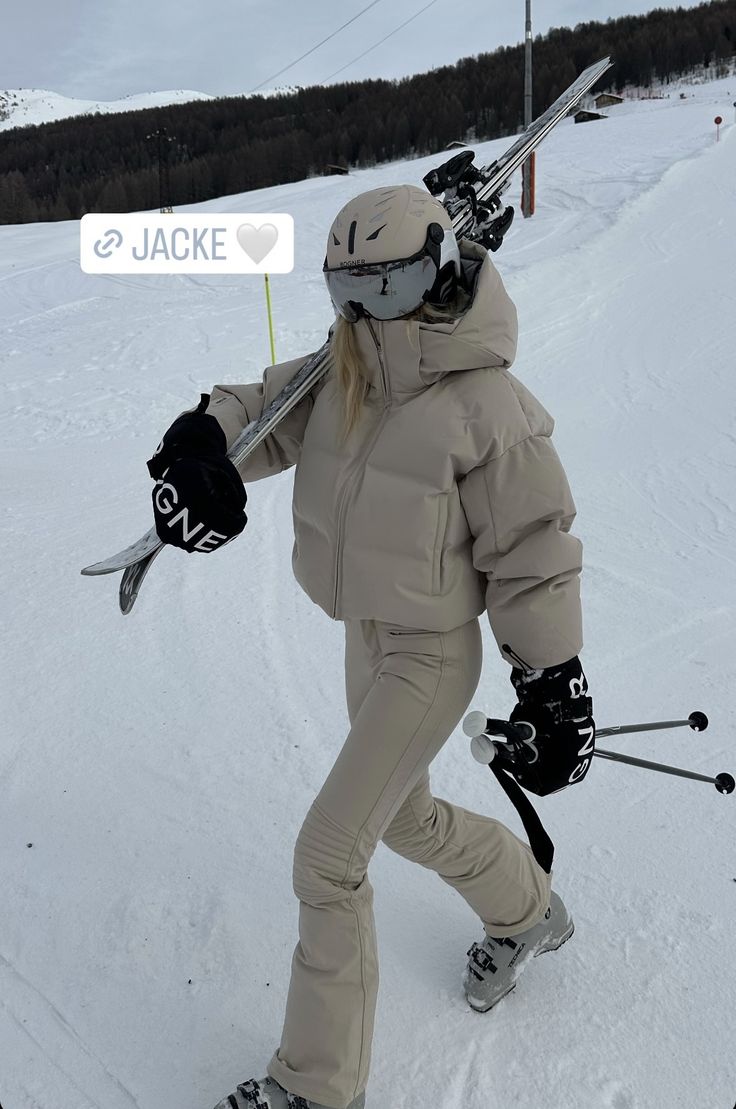 a person on skis holding up a sign with the name jacke written on it