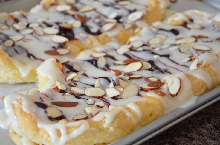 there is a pastry with almonds and icing on it