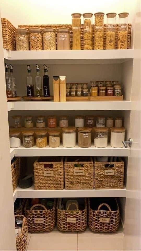 an organized pantry with baskets and food items