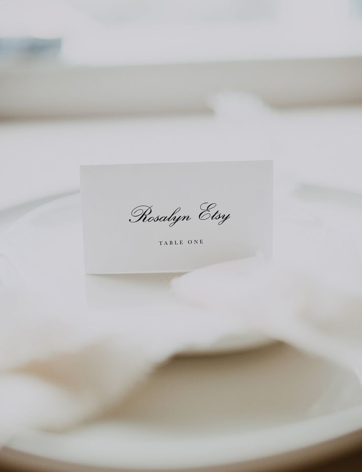 a place card sitting on top of a white plate