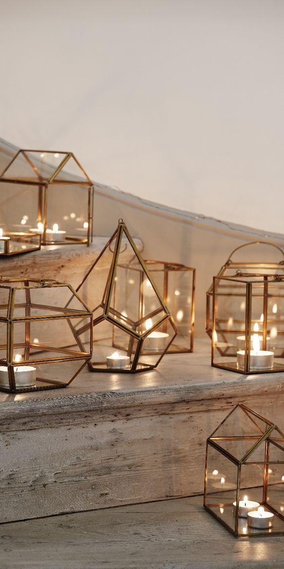 several glass cubes with candles in them sitting on the floor next to each other