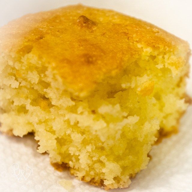 a piece of yellow cake sitting on top of a white paper towel next to a fork