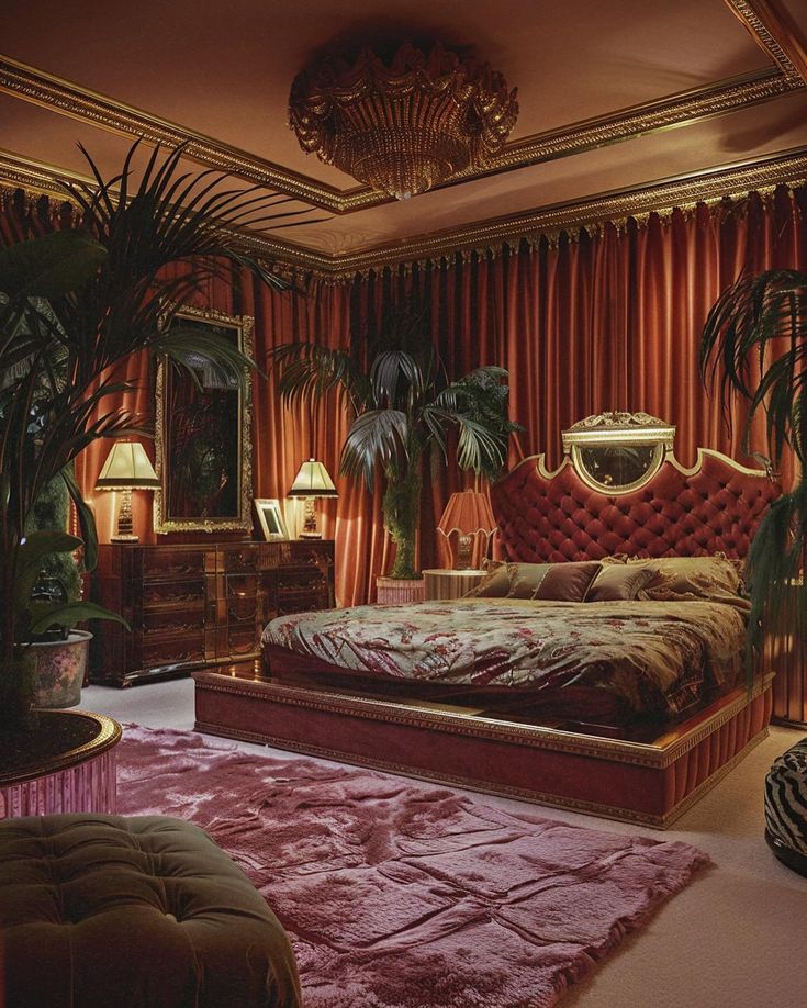 the bedroom is decorated in red, gold and pink tones with palm trees on either side of the bed