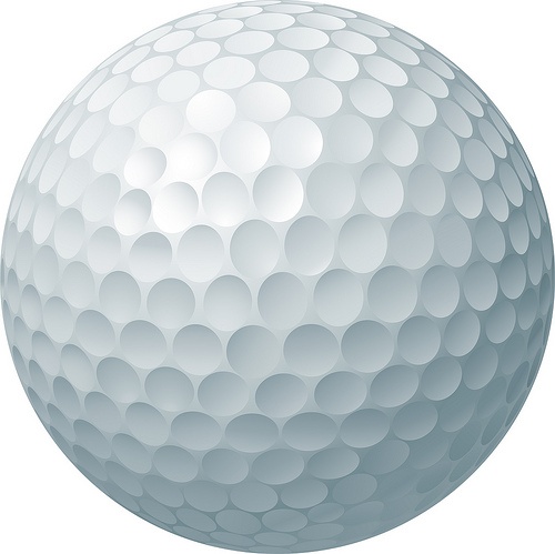 a white golf ball on a white background with lots of small circles in the center