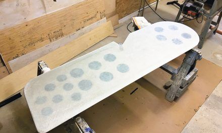 an ironing board is being made in a workshop with wood planks and plywood