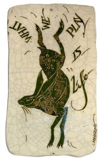 a ceramic tile with a lizard on it's back and words written in black