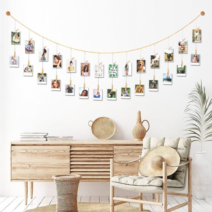 a living room with pictures hanging on the wall and a chair in front of it