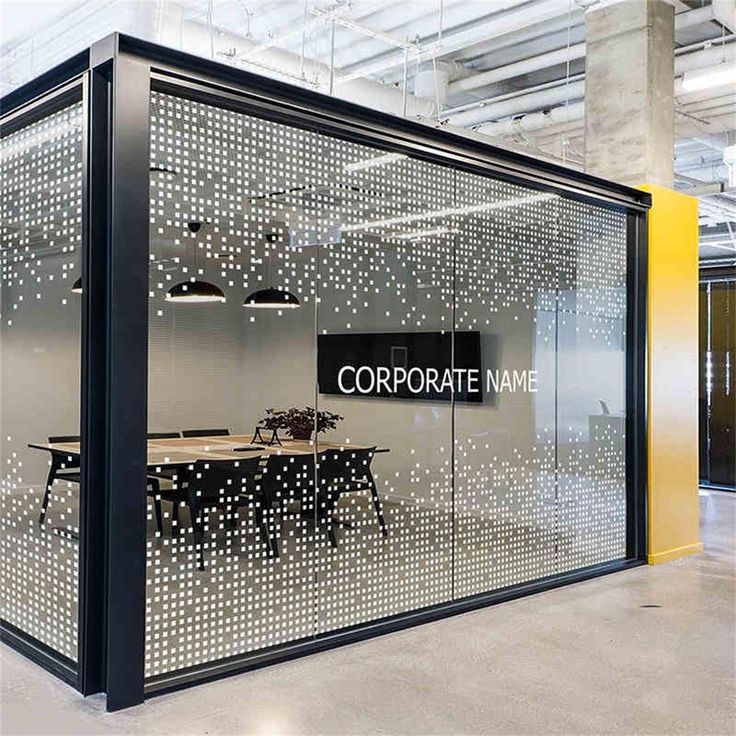 an office cubicle with the words corporate on it's glass walls and tables in front of them