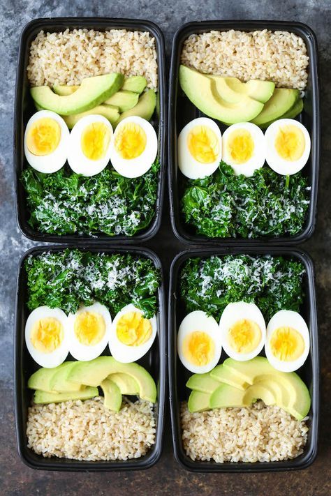 four black trays filled with rice, eggs and veggies on top of each other