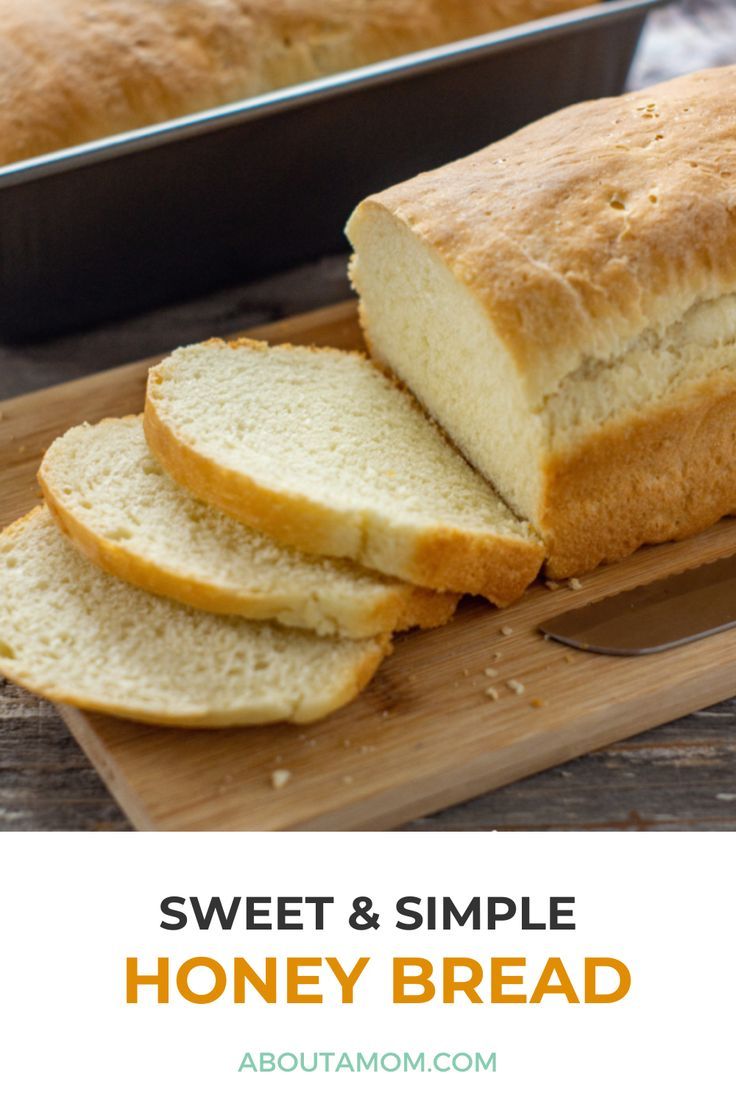 sweet and simple honey bread on a cutting board with a loaf of bread in the background