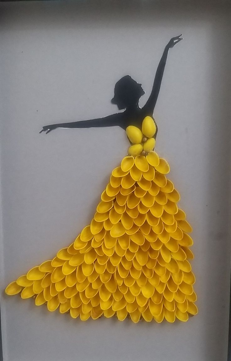 a shadow of a woman in a yellow dress made out of plastic buttons on a white background