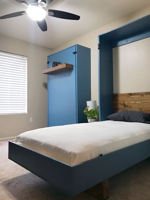 a bed sitting in a bedroom under a ceiling fan