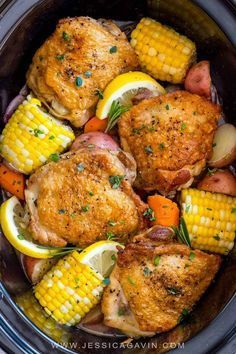 chicken, corn and potatoes in the crock pot with lemon wedges on top