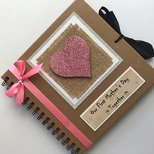 a card with a pink heart on it and a ribbon tied to the front of it