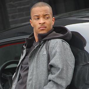 a man standing in front of a black car