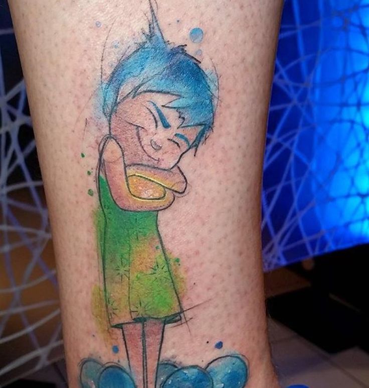 a person with a tattoo on their leg that has an image of a cartoon character