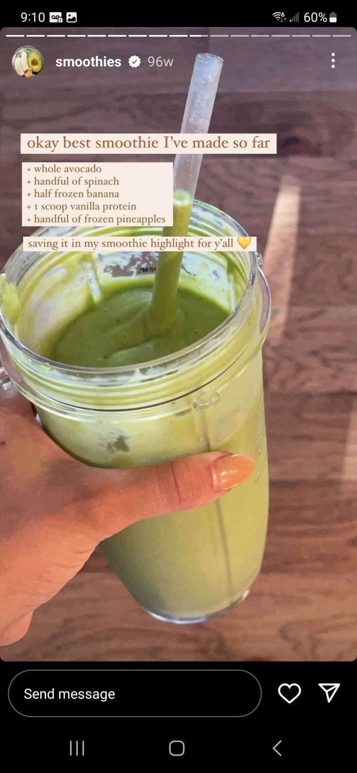 someone holding up a green smoothie in a cup with a sticker on it