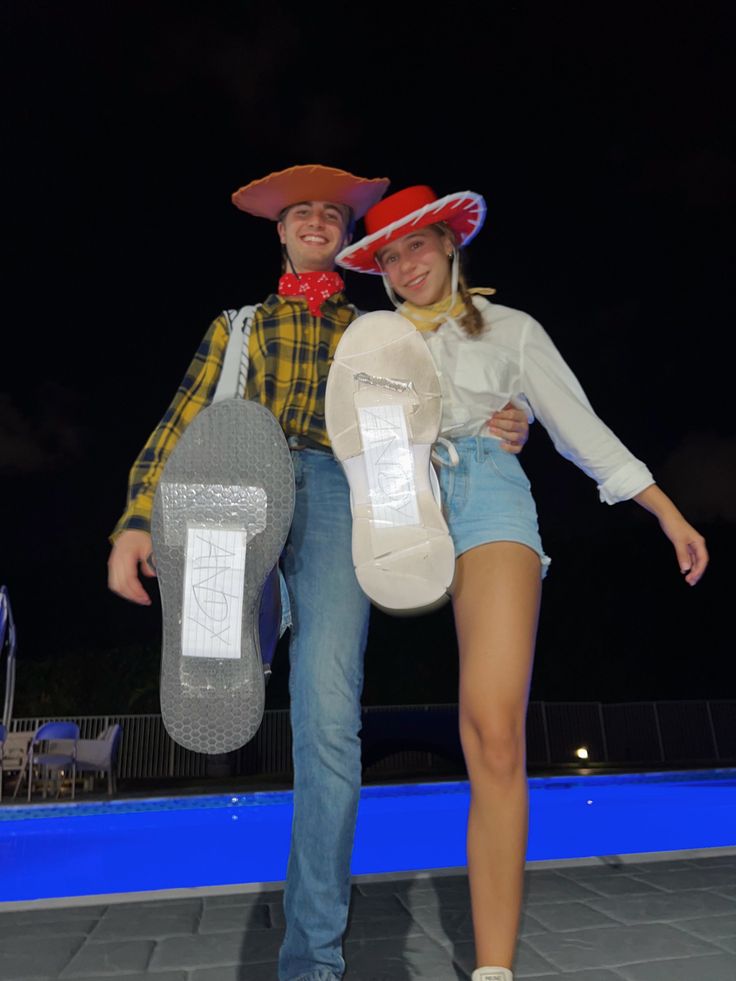 a man and woman dressed in cowboy hats pose for a photo with their skateboards