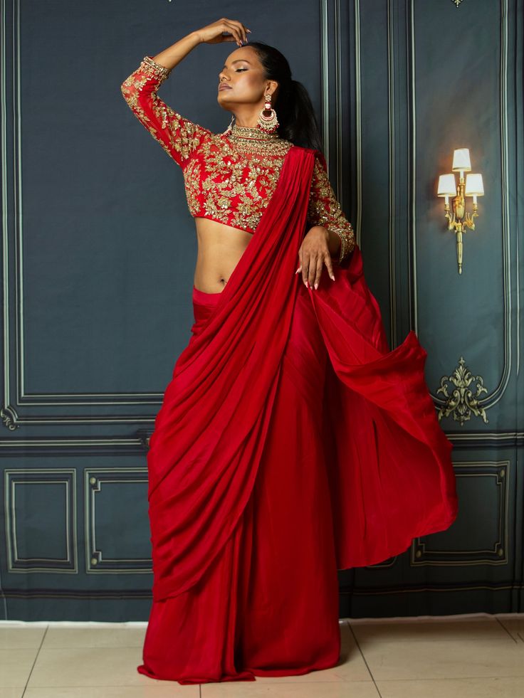 Introducing the Khushboo Saree, a perfect blend of traditional elegance and modern fashion. This saree is designed by VamaDesigns, a renowned brand known for its fusion creations that are perfect for receptions and special occasions. Features: Hot red color that exudes confidence and sophistication. Exquisite embroidery that adds intricate detailing and enhances the overall look. Indo-western fusion design that combines traditional elements with contemporary style. Flattering sleeve and waist de Luxury Bollywood Style Red Pre-draped Saree, Luxury Red Embellished Pre-draped Saree, Festive Red Embellished Saree, Elegant Embroidered Red Pre-draped Saree, Festive Red Embroidered Pre-draped Saree, Buy Lehenga Online, Indian Bridal Couture, Reception Gowns, Elegant Veils