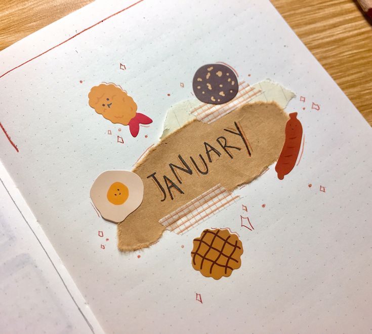 an open book with some stickers on it's cover and the word january written in black