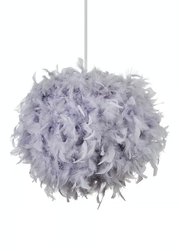 a purple and white feather ball hanging from a ceiling fixture with one light on it