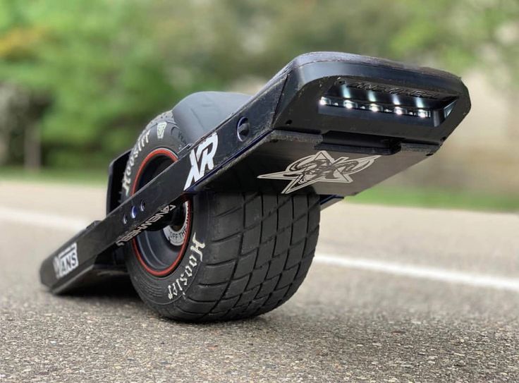 an electric skateboard is laying on the ground