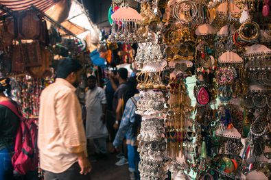 a man standing in front of a store filled with lots of different types of jewelry