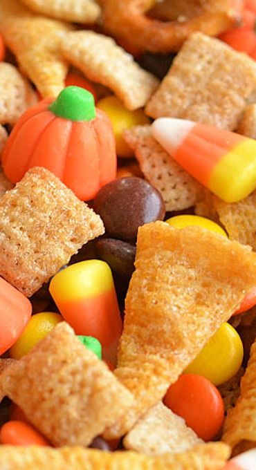 a bowl filled with candy corn and cheetos