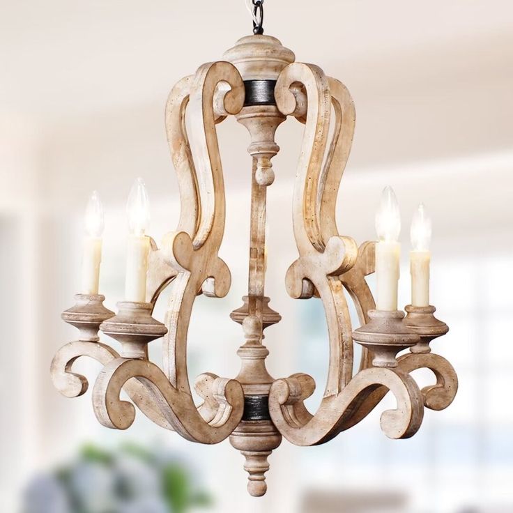 a wooden chandelier with candles hanging from it